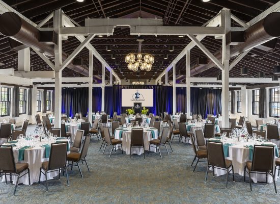 Ballroom with banquet full dinner set-up with round tables in boutique hotel